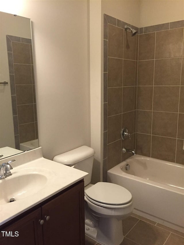 full bathroom with vanity, tiled shower / bath combo, tile patterned floors, and toilet