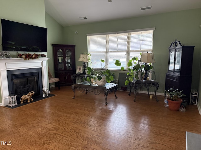 living room featuring vaulted ceiling and hardwood / wood-style floors