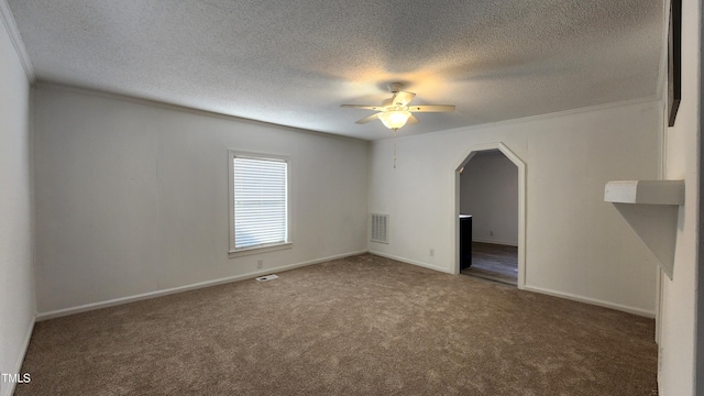 unfurnished room with carpet flooring, a textured ceiling, ceiling fan, and ornamental molding