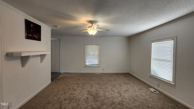 spare room with carpet, ceiling fan, ornamental molding, and a textured ceiling