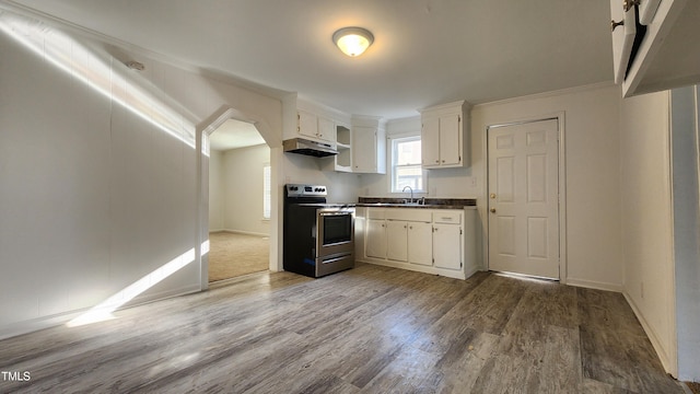 kitchen featuring stainless steel electric stove, white cabinetry, ornamental molding, and hardwood / wood-style flooring