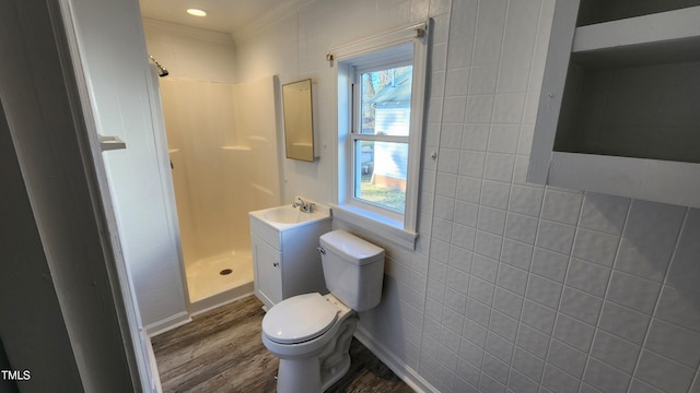 bathroom featuring walk in shower, ornamental molding, toilet, vanity, and hardwood / wood-style flooring