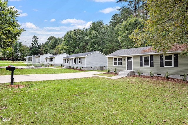 single story home featuring central air condition unit and a front lawn