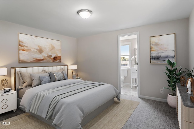 bedroom featuring connected bathroom and carpet floors