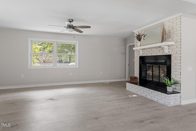 unfurnished living room featuring ceiling fan, a fireplace, and hardwood / wood-style flooring