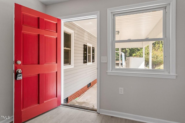 doorway with hardwood / wood-style flooring