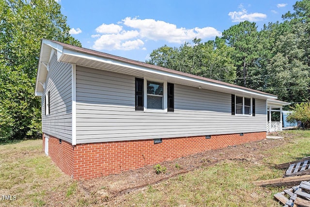 view of side of home featuring a lawn