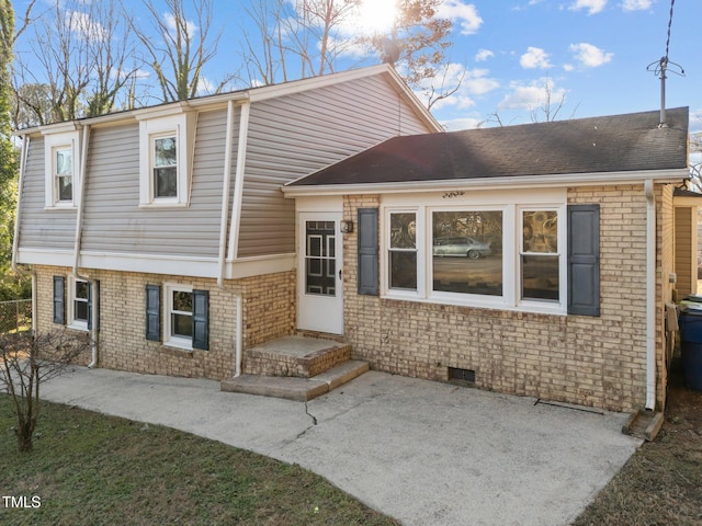 tri-level home with a patio