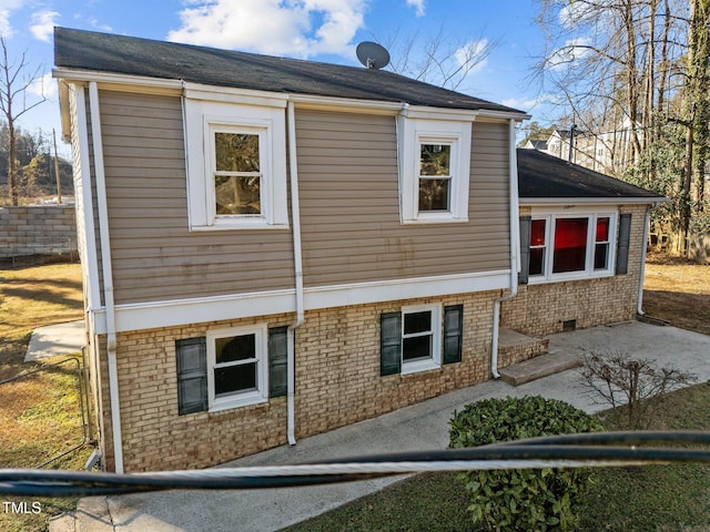 view of property exterior with a patio area