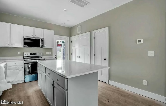 kitchen featuring white cabinetry, light hardwood / wood-style floors, a kitchen island, gray cabinetry, and appliances with stainless steel finishes