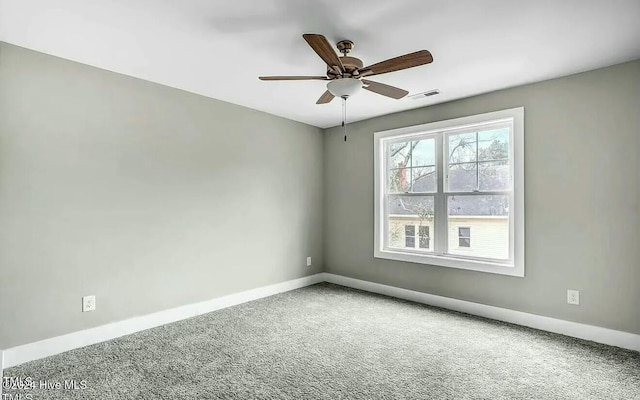 carpeted spare room featuring ceiling fan