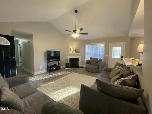 living room with lofted ceiling, ceiling fan, and light hardwood / wood-style flooring