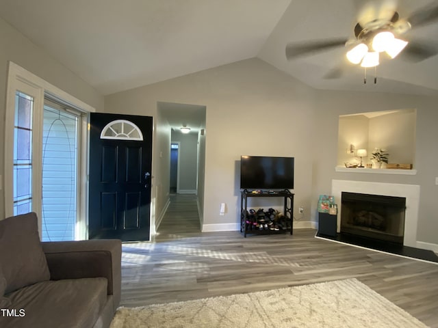 living room featuring lofted ceiling, wood-type flooring, and ceiling fan