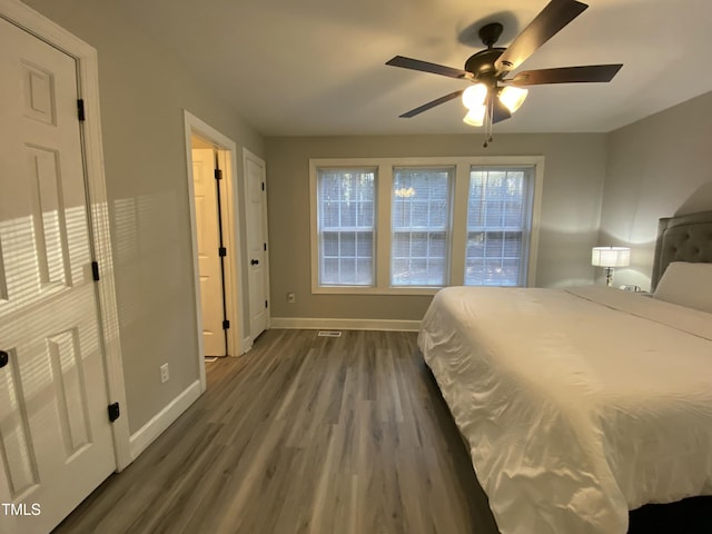 bedroom with ceiling fan and dark hardwood / wood-style floors