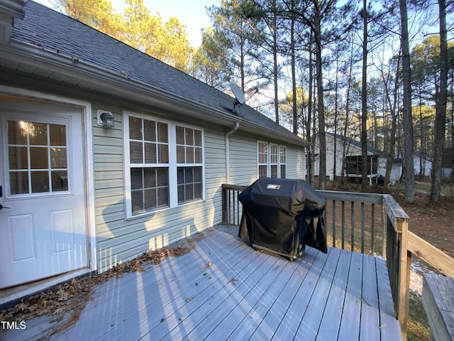 wooden deck featuring a grill