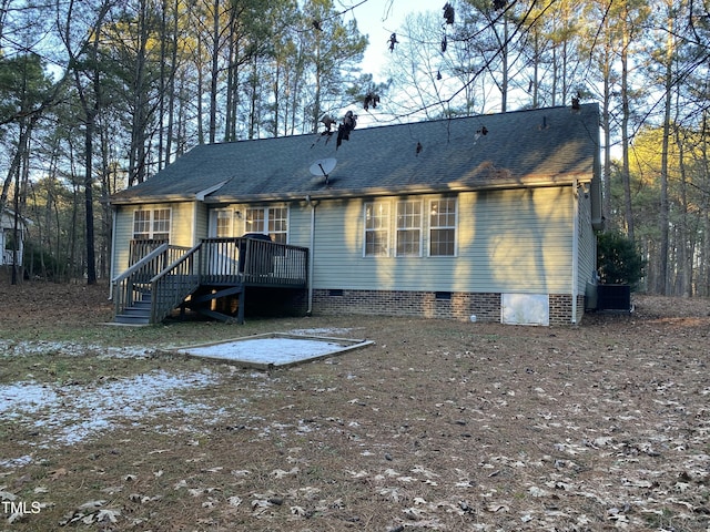 back of property featuring a deck and central AC