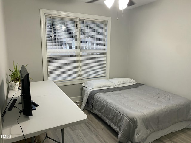 bedroom with hardwood / wood-style flooring and ceiling fan