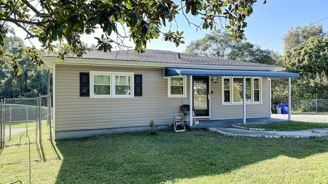 bungalow-style house featuring a front yard and a patio