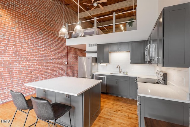 kitchen with appliances with stainless steel finishes, wooden ceiling, pendant lighting, gray cabinetry, and beam ceiling