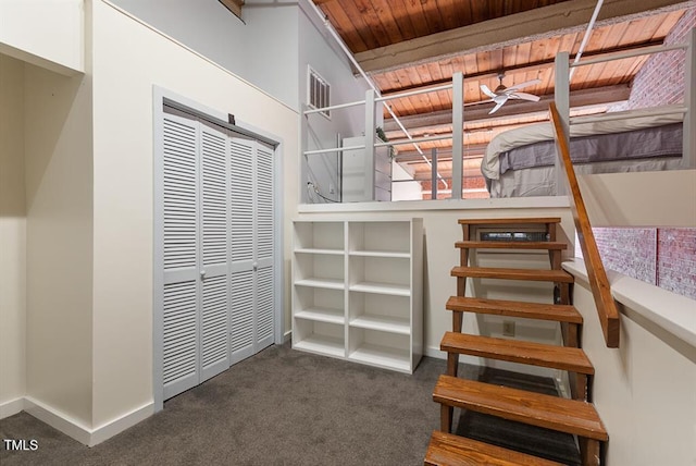 stairs featuring carpet flooring and wooden ceiling