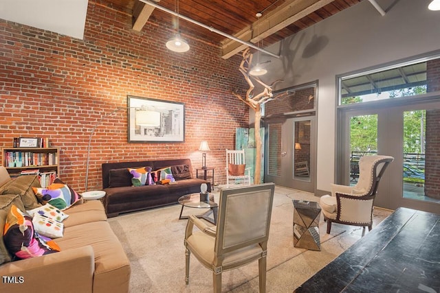 living room featuring a towering ceiling, brick wall, beam ceiling, and wood ceiling