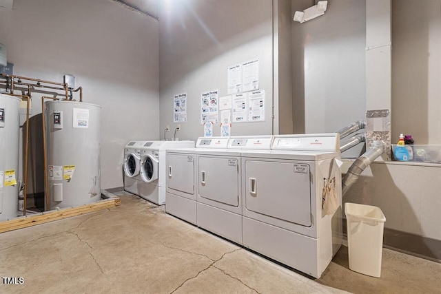 laundry area featuring water heater and washer and clothes dryer