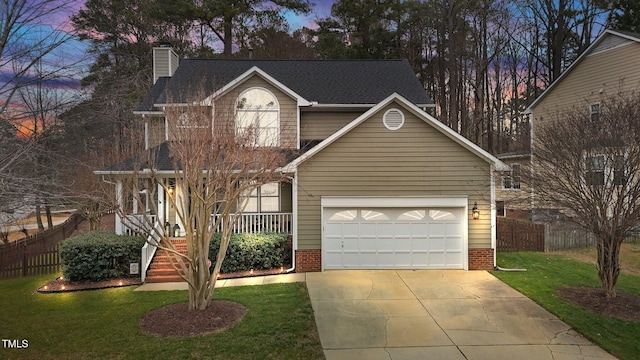 view of front of home featuring a yard, covered porch, and a garage