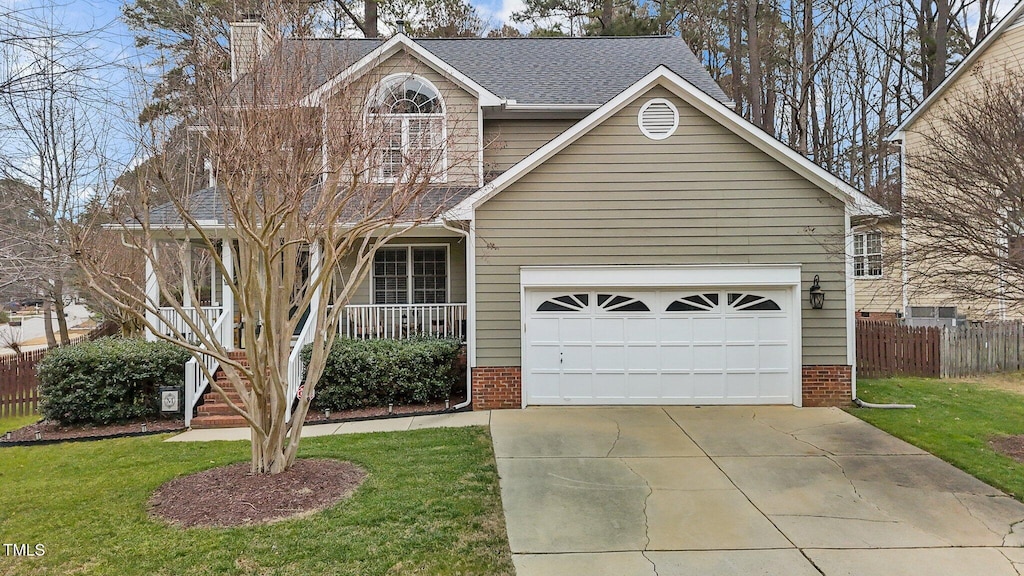 view of front of house with covered porch, a front lawn, and a garage