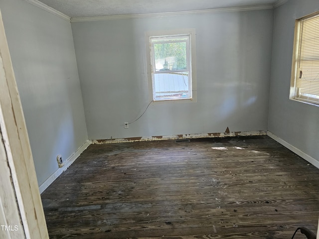 empty room featuring dark hardwood / wood-style flooring and ornamental molding