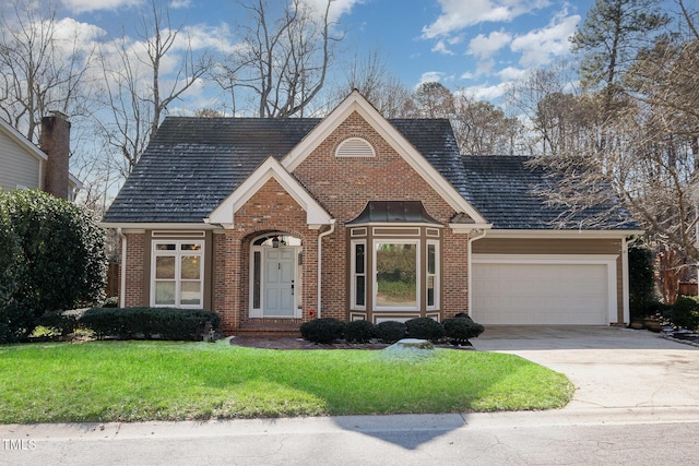 view of front of home featuring a garage and a front lawn