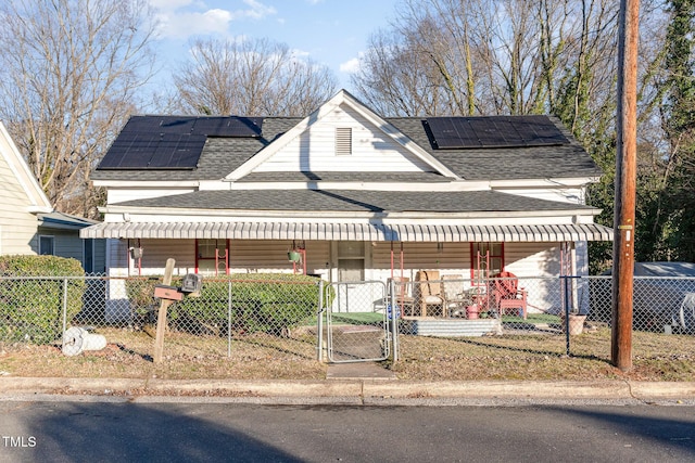 view of front of property featuring covered porch and solar panels