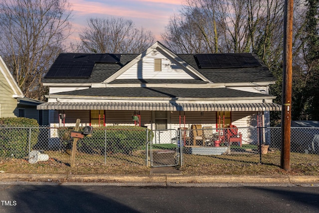 view of front facade featuring a porch and solar panels