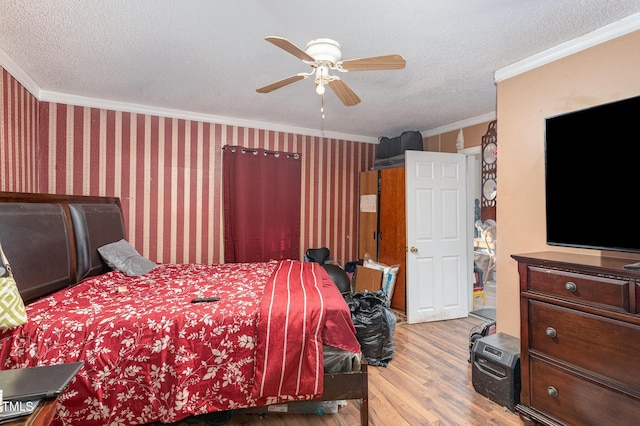 bedroom featuring crown molding, ceiling fan, light hardwood / wood-style flooring, and a textured ceiling