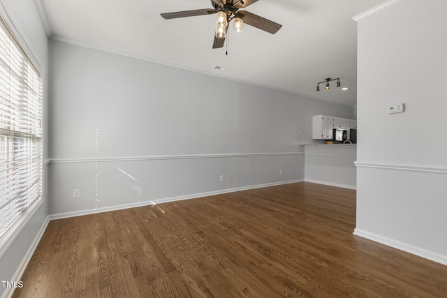 interior space with hardwood / wood-style flooring, ceiling fan, vaulted ceiling, and ornamental molding