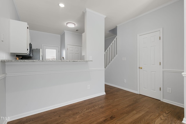 unfurnished living room with dark hardwood / wood-style flooring and crown molding