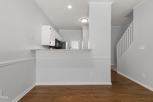 kitchen featuring white cabinets, crown molding, stainless steel refrigerator, and dark hardwood / wood-style floors