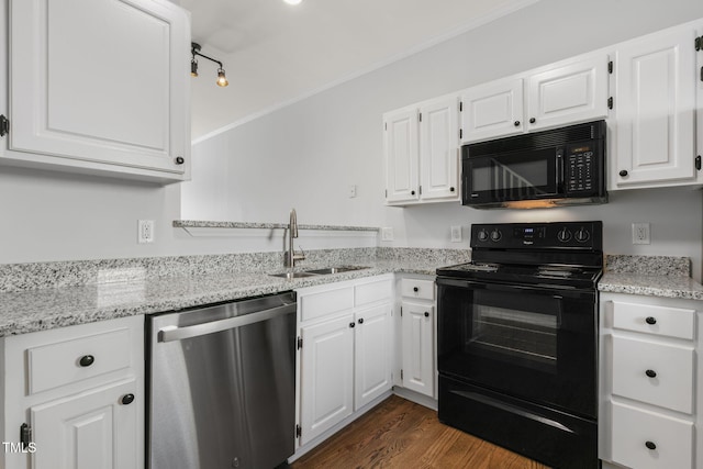 kitchen featuring sink, black appliances, white cabinets, and light stone counters