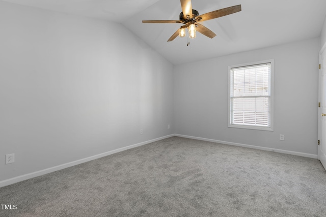 carpeted empty room featuring vaulted ceiling and ceiling fan