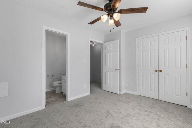 unfurnished bedroom featuring ceiling fan, connected bathroom, light carpet, and a closet