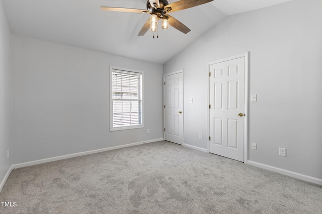 unfurnished bedroom with light carpet, vaulted ceiling, and ceiling fan