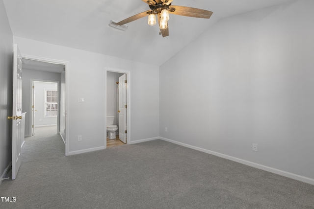 unfurnished bedroom featuring ceiling fan, ensuite bath, light colored carpet, and lofted ceiling