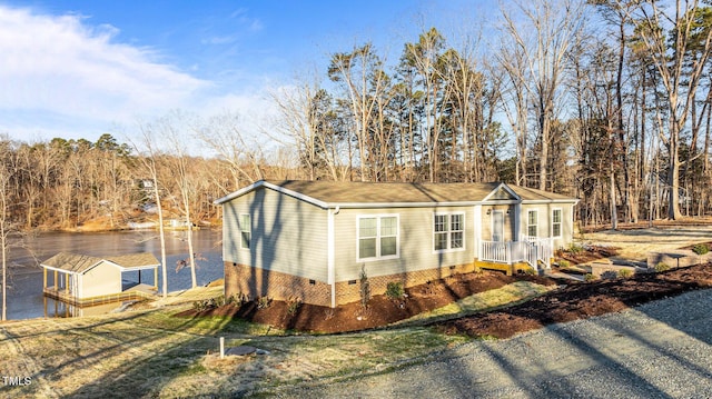 view of front of house with a water view