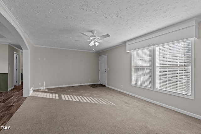 unfurnished room featuring crown molding, a textured ceiling, ceiling fan, and carpet flooring