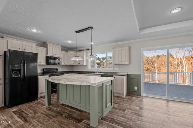 kitchen featuring a kitchen island, decorative light fixtures, dark hardwood / wood-style flooring, black appliances, and crown molding