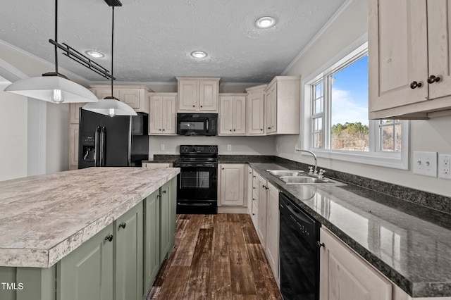 kitchen featuring sink, hanging light fixtures, green cabinets, black appliances, and crown molding