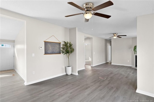 unfurnished living room with ceiling fan and wood-type flooring