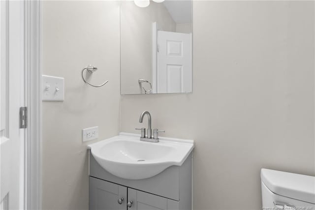 bathroom with toilet and vanity