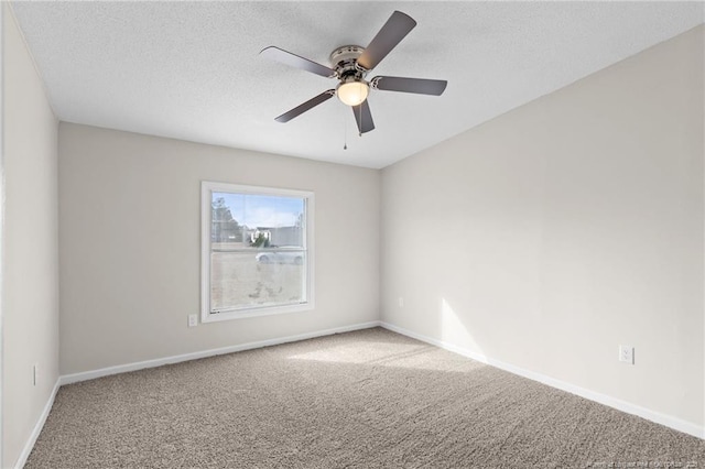 carpeted empty room with ceiling fan and a textured ceiling