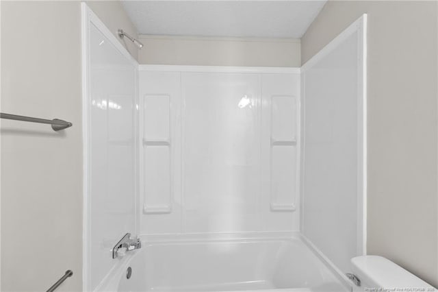 bathroom with toilet and shower / bath combination