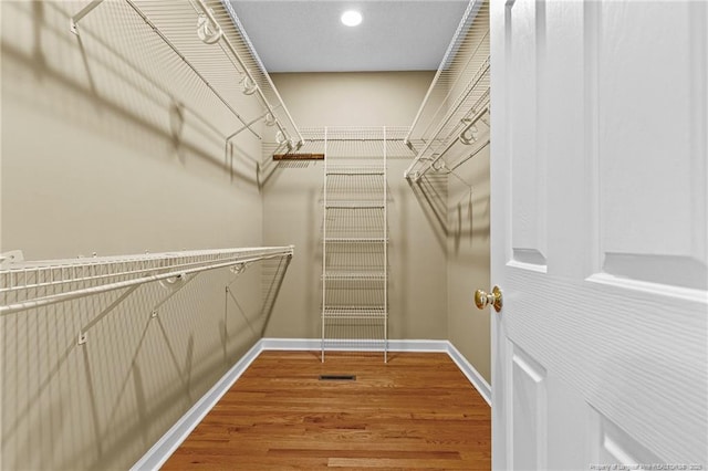 spacious closet with hardwood / wood-style floors